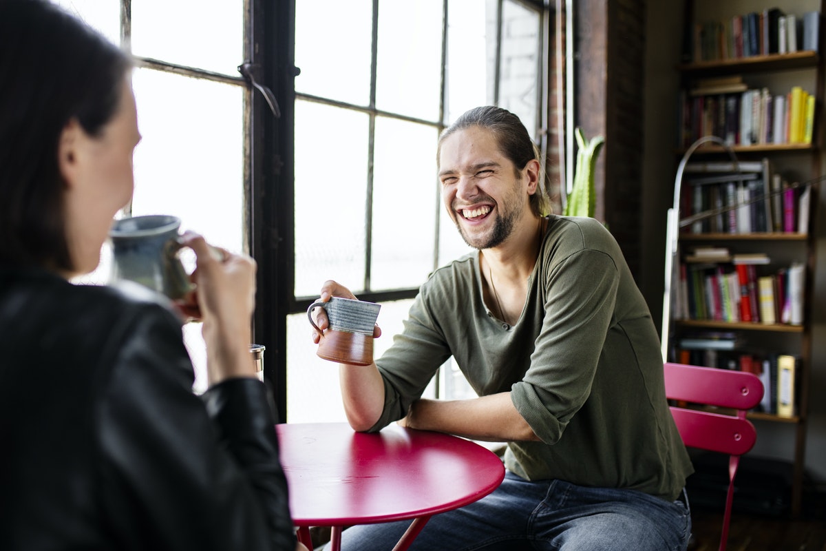 man-at-coffee-shop-smiling-laughing-Valiant-Living-Recovery