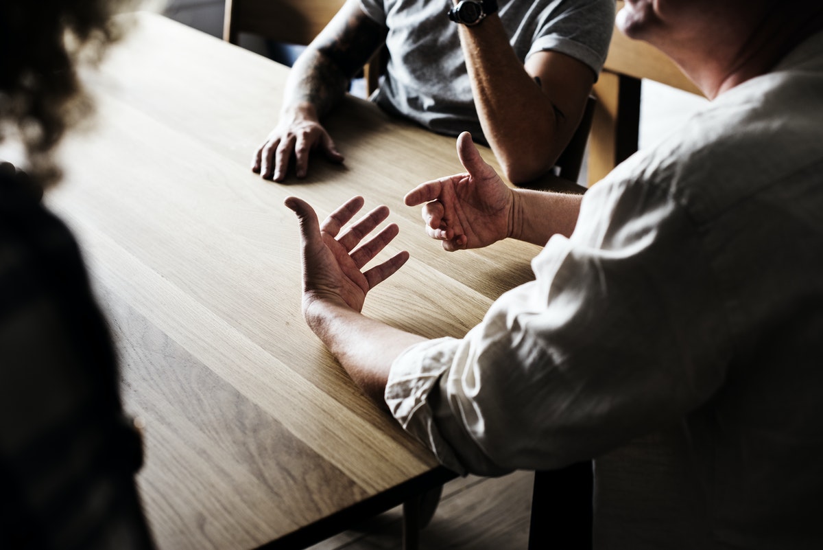 men-at-table-talking-Valiant-Living-Recovery