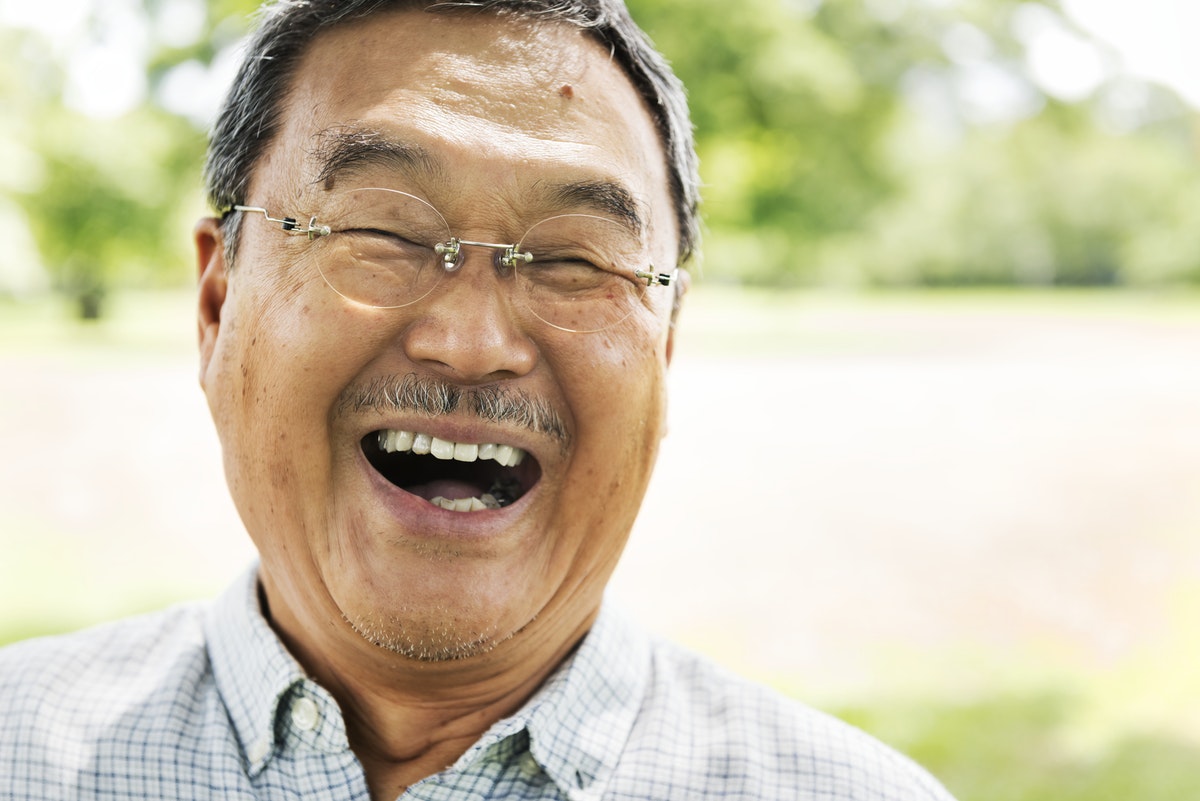Closeup of a man smiling in a park