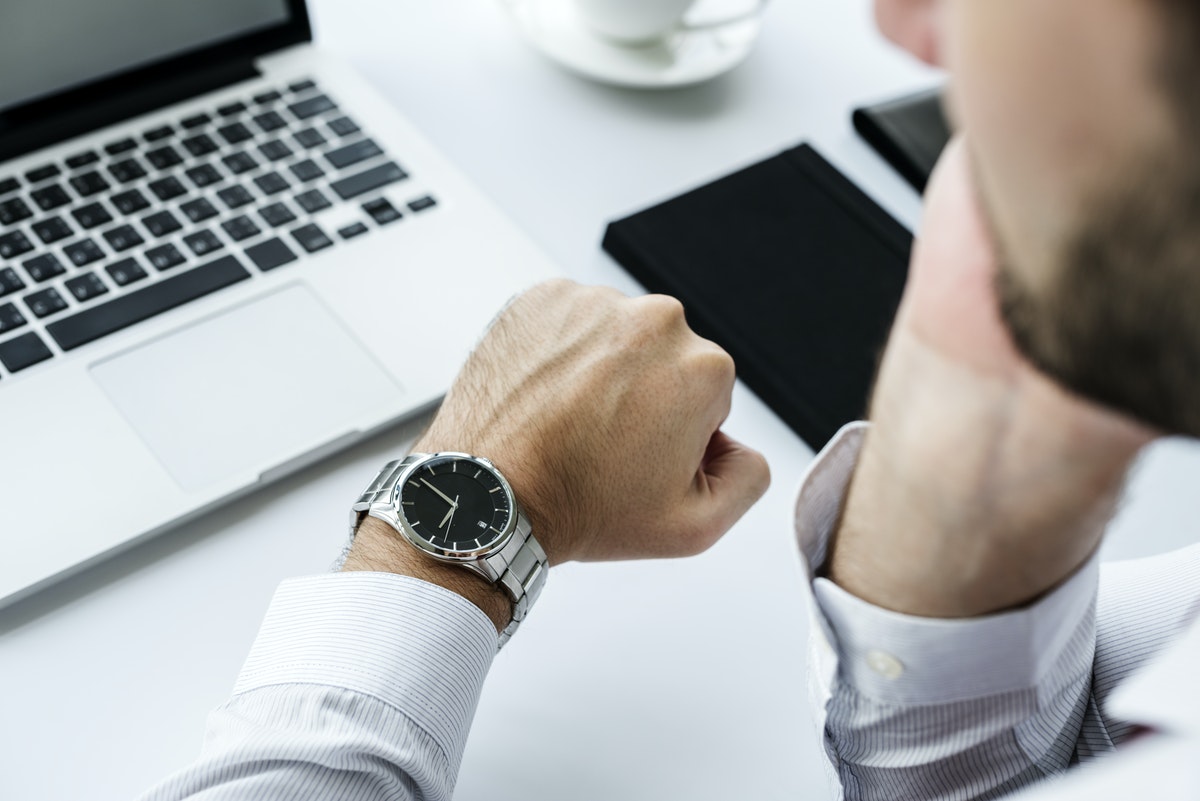 Closeup of man checking time on hand watch