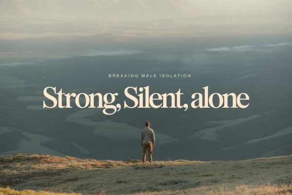 Man standing alone on a mountain overlooking a vast landscape, symbolizing men's recovery and streng.