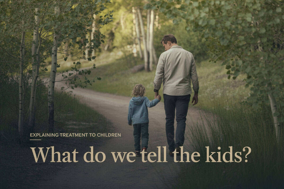 Father and child walking outdoors in nature, discussing treatment and recovery.